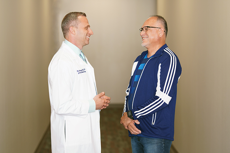 Dr. Mazen Iskandar hernia surgeon talking with smiling patient